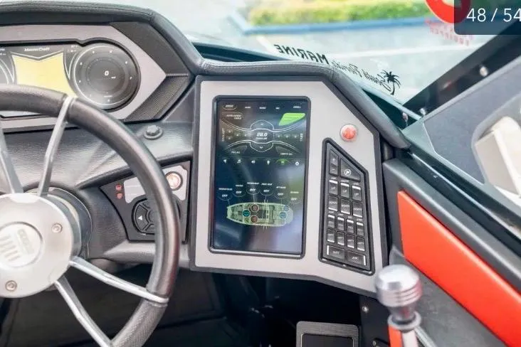 Slide: The Image of 2019 MasterCraft XStar dashboard with touchscreen controls and steering wheel. - 8