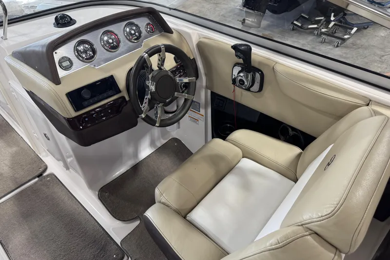 Slide: The Image of 2015 Regal 2700 Bowrider cockpit with steering wheel and control panel. - 10
