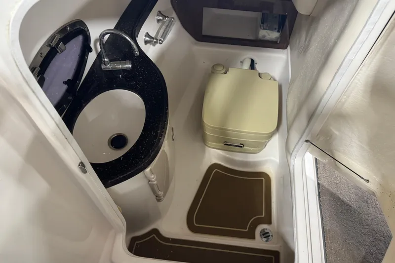 Slide: The Image of 2015 Regal 2700 Bowrider boat bathroom with sink and portable toilet. - 12