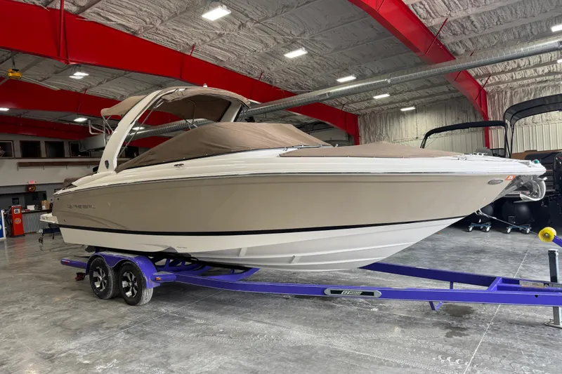 Slide: The Image of 2015 Regal 2700 Bowrider boat on trailer in indoor storage facility. - 13