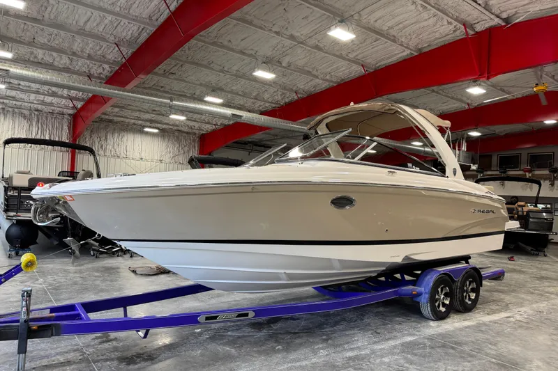 Slide: The Image of 2015 Regal 2700 Bowrider boat on a trailer in a warehouse setting. - 2