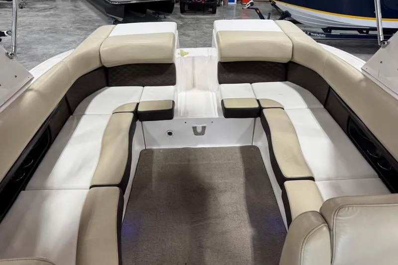 Slide: The Image of 2015 Regal 2700 Bowrider interior with beige seating and carpeted floor. - 7