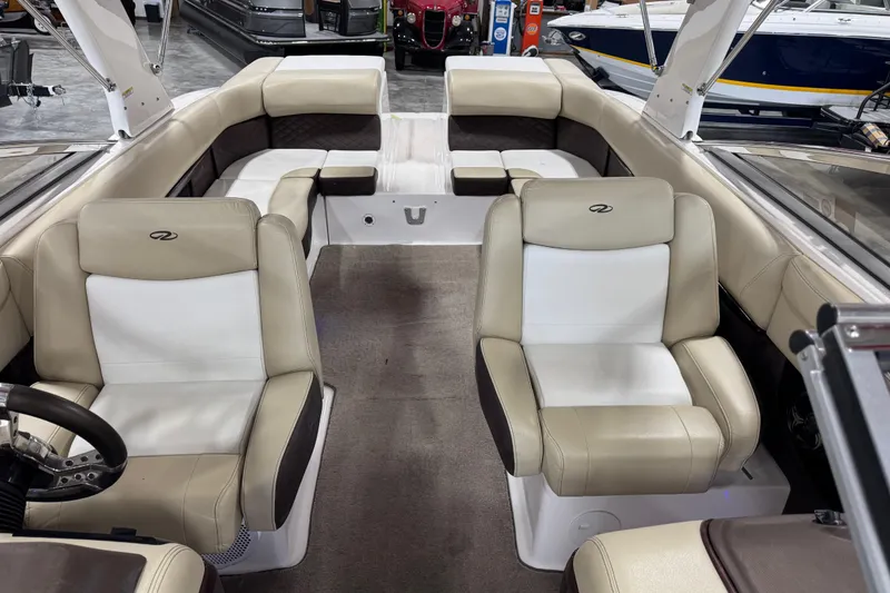 Slide: The Image of Interior of a 2015 Regal 2700 Bowrider boat with beige and white seating. - 8