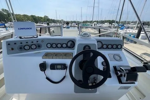 Slide: The Image of 1994 Carver 310 Santego boat dashboard with steering wheel and navigation instruments. - 3