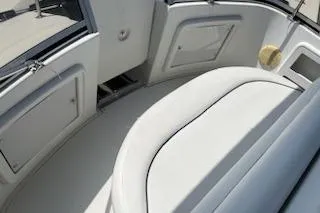 Slide: The Image of 1994 Carver 310 Santego boat interior with white seating and storage compartments. - 4