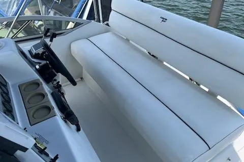 Slide: The Image of 1994 Carver 310 Santego boat interior with white seating and control panel. - 5