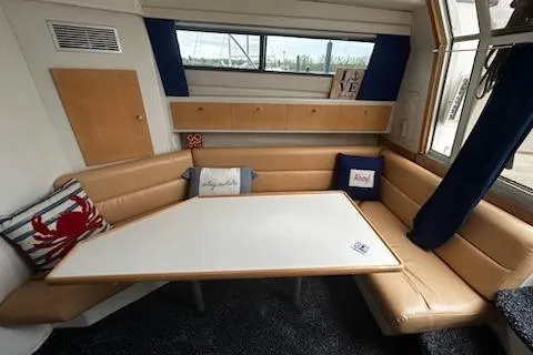 Slide: The Image of Interior of 1994 Carver 310 Santego with beige seating and nautical decor. - 8