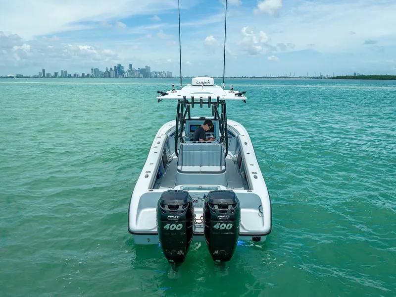 Slide: The Image of 2021 Yellowfin 29 Offshore boat on open sea with city skyline in background. - 11