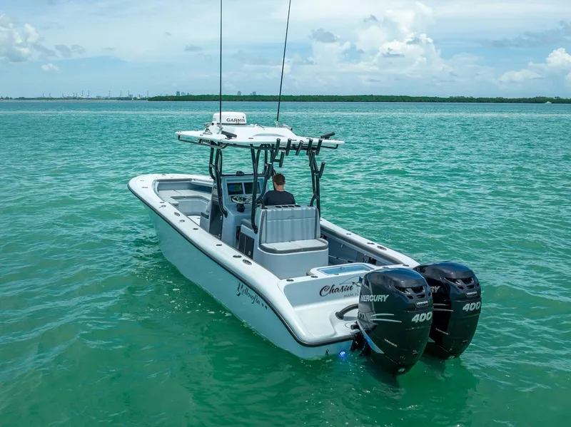 Slide: The Image of 2021 Yellowfin 29 Offshore boat on turquoise water. - 12