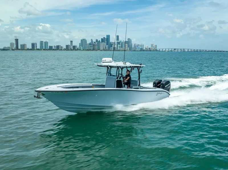 Slide: The Image of 2021 Yellowfin 29 Offshore boat cruising near city skyline. - 18