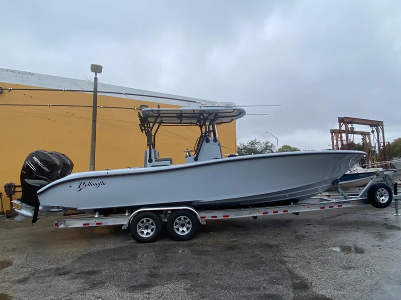 Slide: The Image of 2021 Yellowfin 29 Offshore boat on trailer in front of yellow wall. - 27