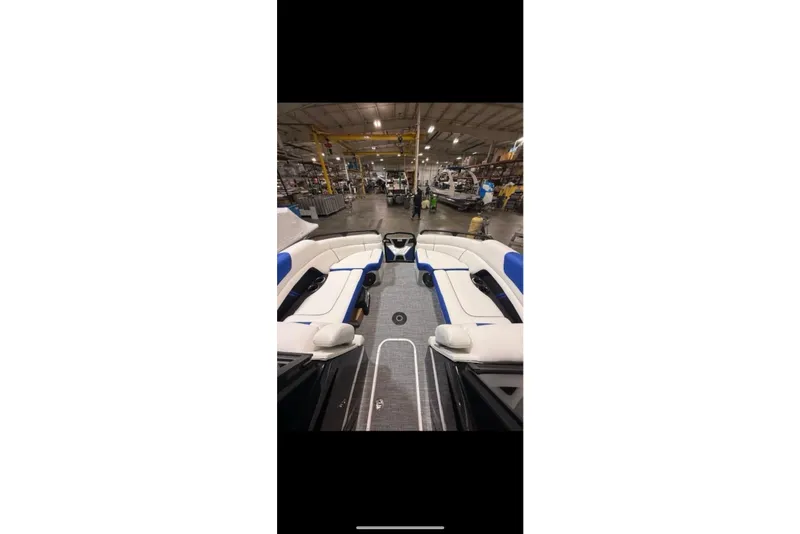 Slide: The Image of Interior view of 2026 South Bay 25 Sport Twin boat in a showroom. - 19