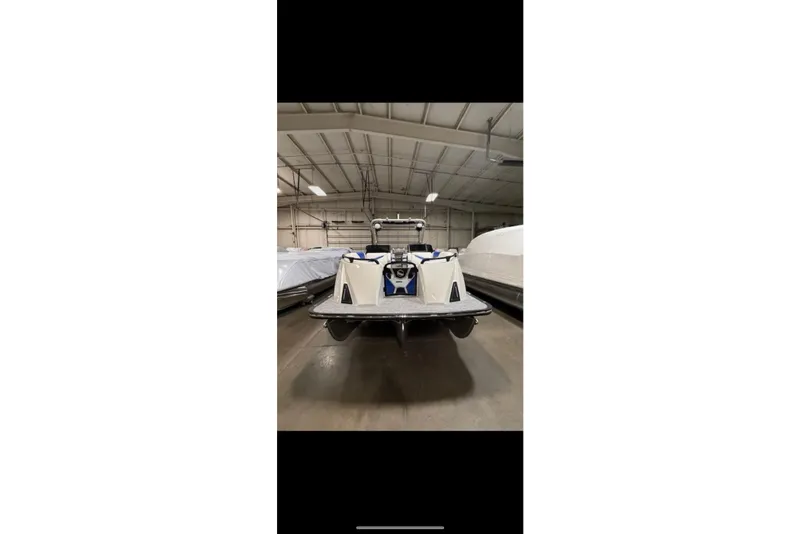 Slide: The Image of 2026 South Bay 25 Sport Twin boat in indoor storage facility. - 3