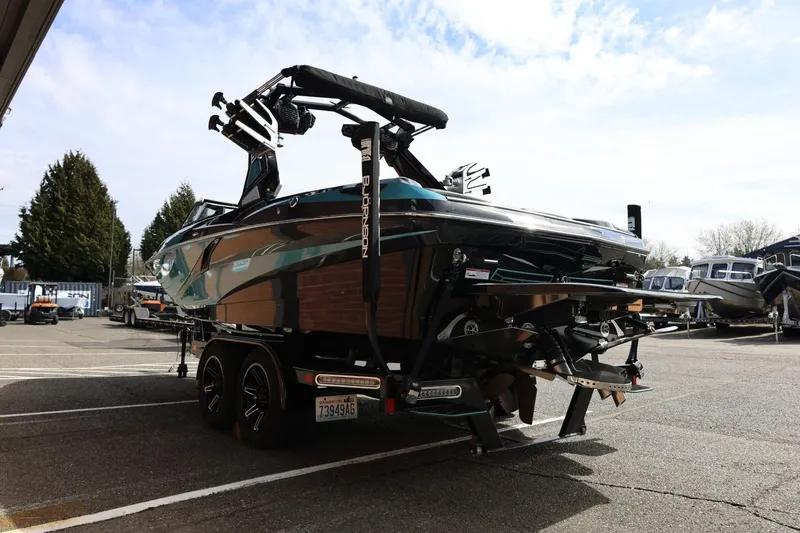 Slide: The Image of 2021 Centurion Fi23 boat on trailer in parking lot, rear view. - 10