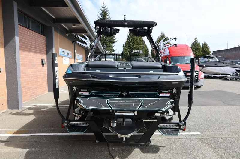 Slide: The Image of 2021 Centurion Fi23 boat rear view at dealership, showcasing sleek design and features. - 11
