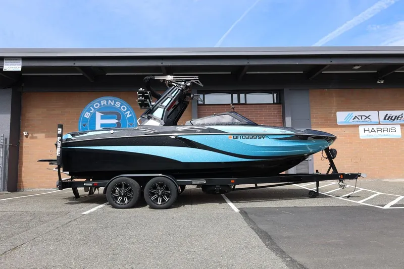 Slide: The Image of 2021 Centurion Fi23 boat on trailer, parked outside Bjornson building. - 2