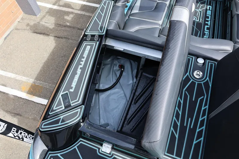 Slide: The Image of 2021 Centurion Fi23 boat interior with open storage compartment and sleek design. - 23