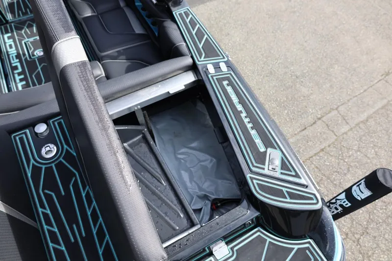 Slide: The Image of 2021 Centurion Fi23 boat interior with open storage compartment and sleek design. - 24