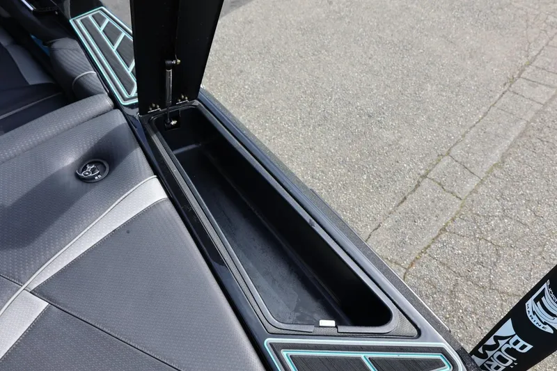 Slide: The Image of 2021 Centurion Fi23 boat interior storage compartment with sleek design and modern upholstery. - 27