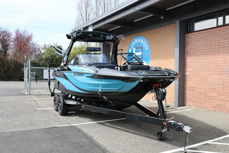 Slide: The Image of 2021 Centurion Fi23 boat on trailer, parked outside a building. - 3