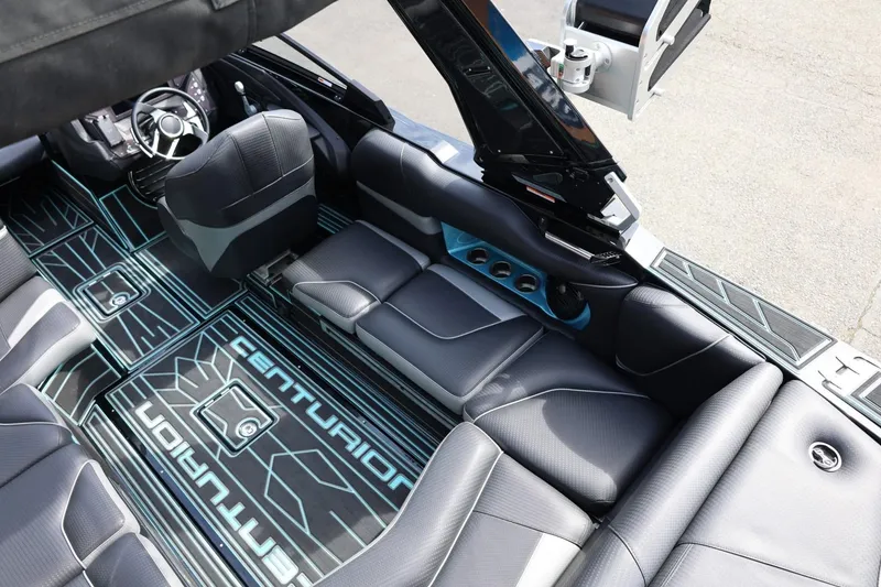 Slide: The Image of 2021 Centurion Fi23 boat interior with sleek black seating and modern dashboard design. - 30