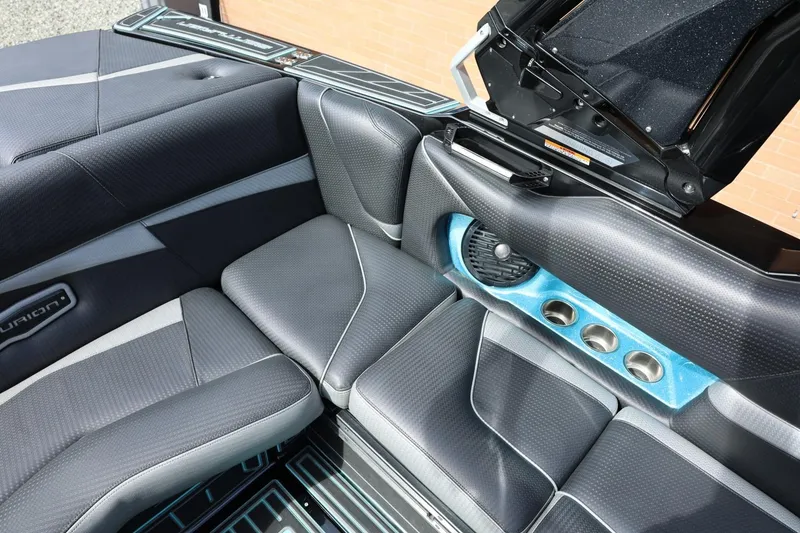 Slide: The Image of 2021 Centurion Fi23 boat interior with sleek black and gray seating and blue accents. - 34