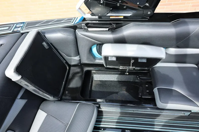 Slide: The Image of 2021 Centurion Fi23 boat interior storage compartment with open seats and sleek design. - 40