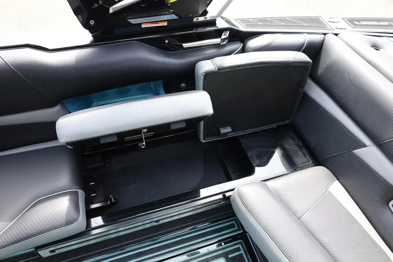 Slide: The Image of 2021 Centurion Fi23 boat interior with open storage compartment and sleek seating design. - 43