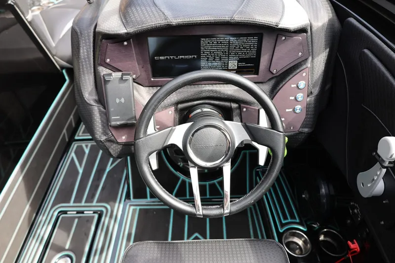 Slide: The Image of 2021 Centurion Fi23 boat dashboard with modern steering wheel and digital display. - 46