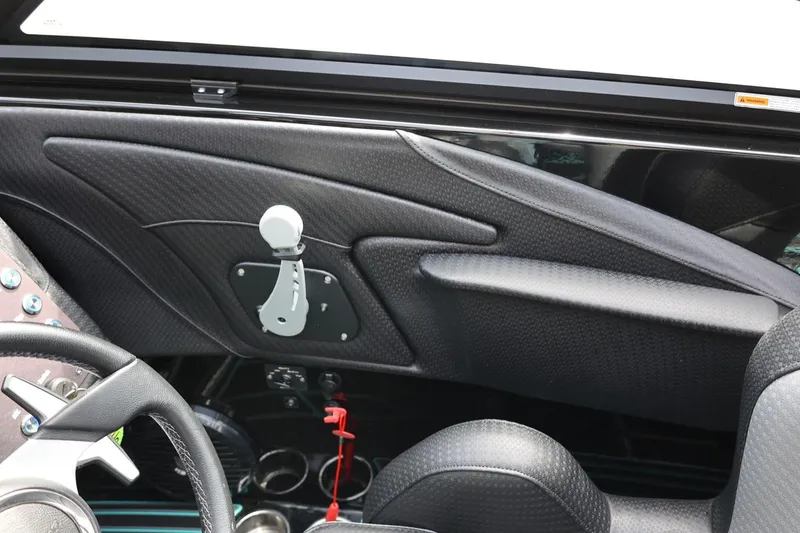 Slide: The Image of Interior of 2021 Centurion Fi23 boat, featuring sleek black carbon fiber accents. - 47