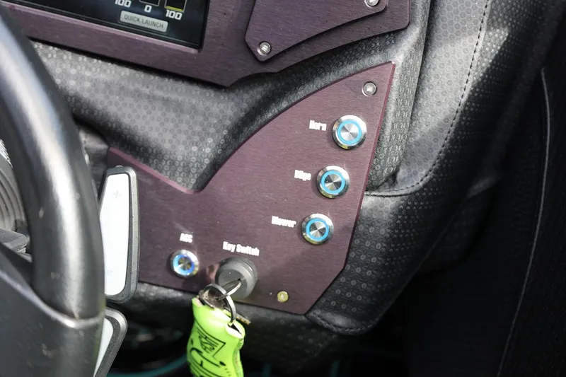 Slide: The Image of 2021 Centurion Fi23 dashboard with control panel and key switch. - 48