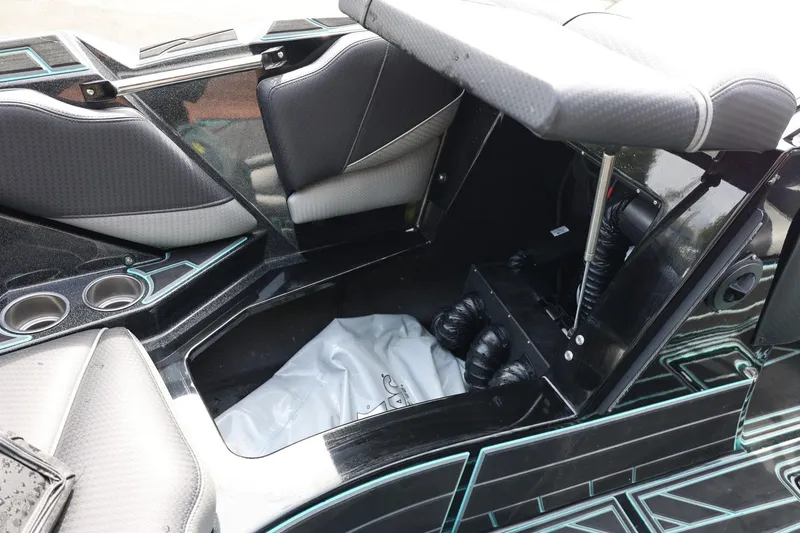 Slide: The Image of Interior storage compartment of 2021 Centurion Fi23 boat with cup holders and seating. - 57