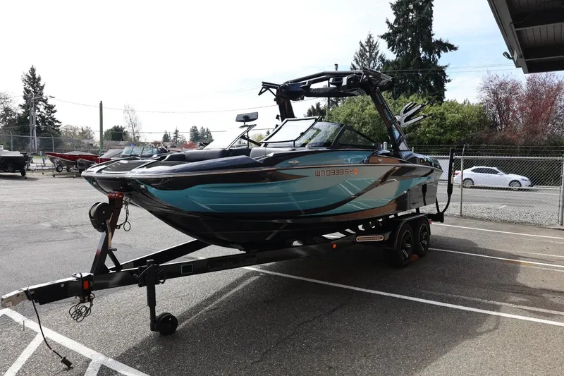 Slide: The Image of 2021 Centurion Fi23 boat on trailer in parking lot, side view. - 7