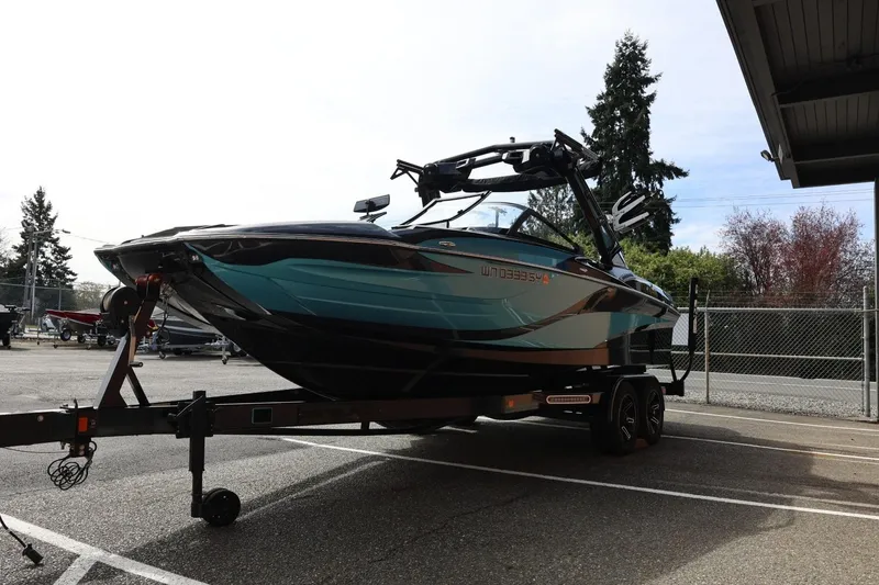 Slide: The Image of 2021 Centurion Fi23 boat on trailer in parking lot, side view. - 8