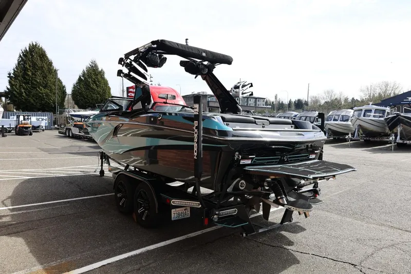 Slide: The Image of 2021 Centurion Fi23 boat on trailer in a marina parking lot. - 9