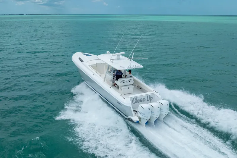 Slide: The Image of 2015 Intrepid 400 Cuddy cruising on turquoise ocean waters. - 10