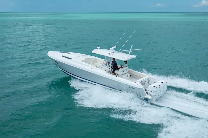 Slide: The Image of 2015 Intrepid 400 Cuddy cruising on turquoise ocean waters. - 11