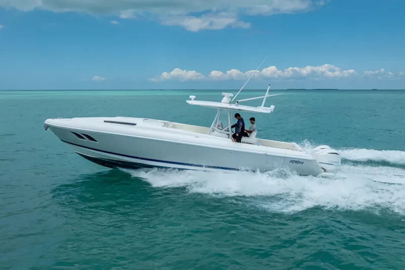 Slide: The Image of 2015 Intrepid 400 Cuddy cruising on turquoise ocean waters under a clear blue sky. - 12