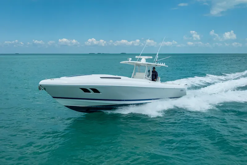 Slide: The Image of 2015 Intrepid 400 Cuddy cruising on clear blue ocean waters. - 13