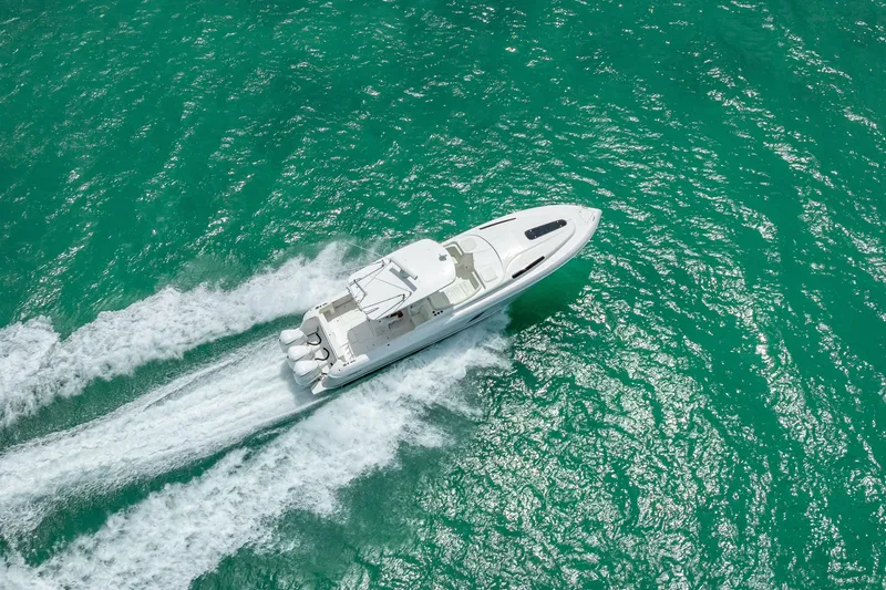 Slide: The Image of Aerial view of 2015 Intrepid 400 Cuddy boat cruising on turquoise water. - 14