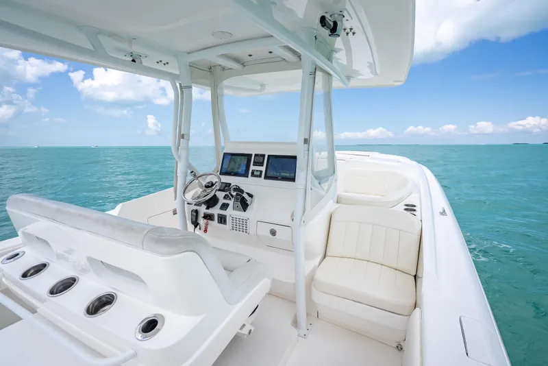Slide: The Image of 2015 Intrepid 400 Cuddy boat interior with helm, seating, and ocean view. - 17