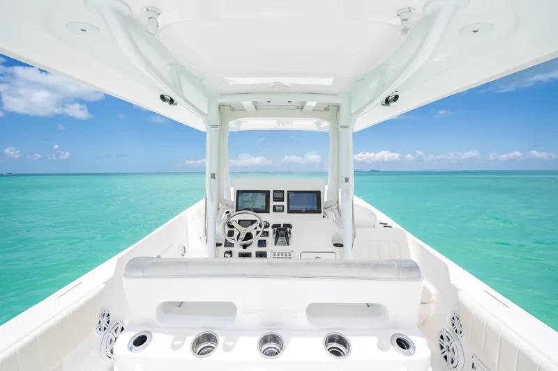 Slide: The Image of Cockpit view of 2015 Intrepid 400 Cuddy boat on turquoise ocean waters. - 18