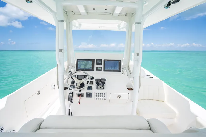Slide: The Image of 2015 Intrepid 400 Cuddy helm with ocean view, featuring modern navigation equipment. - 19