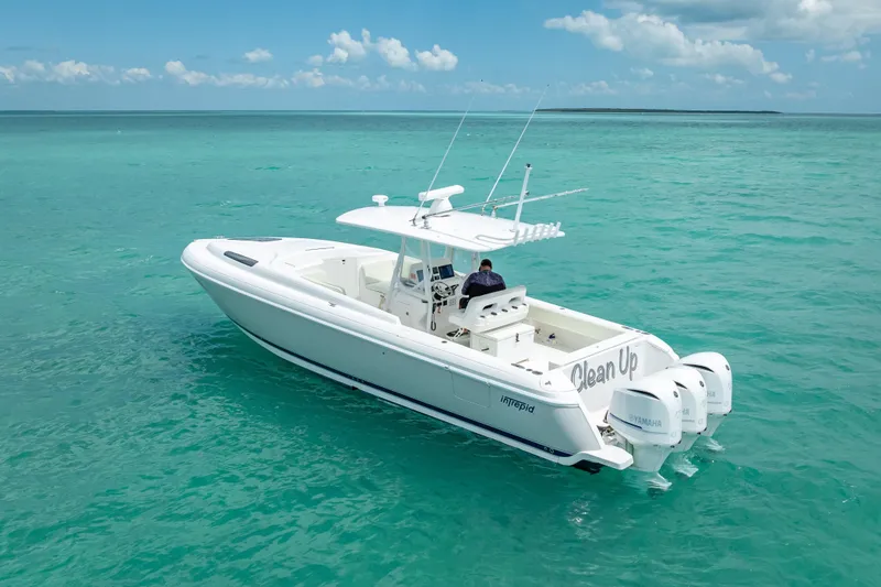 Slide: The Image of 2015 Intrepid 400 Cuddy boat cruising on clear turquoise waters under a blue sky. - 2