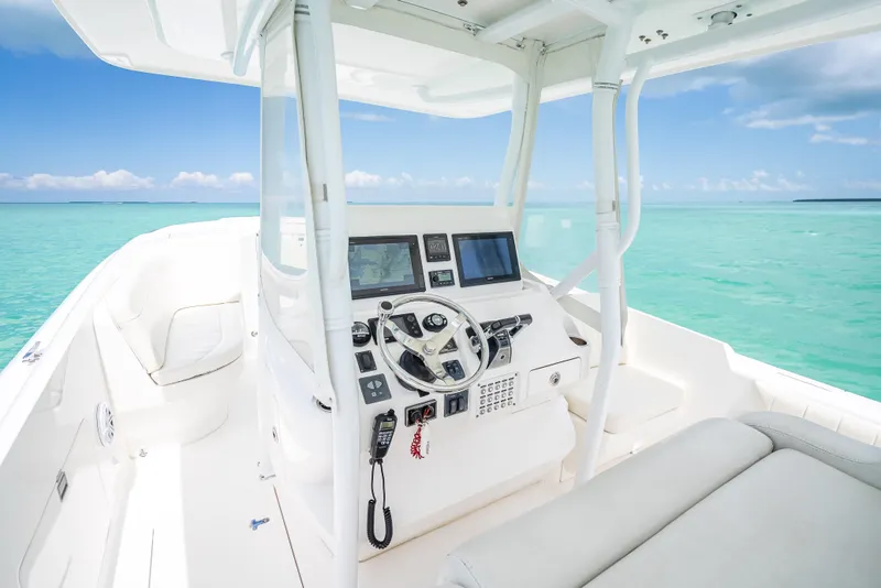 Slide: The Image of 2015 Intrepid 400 Cuddy boat interior with ocean view, featuring modern navigation equipment. - 20