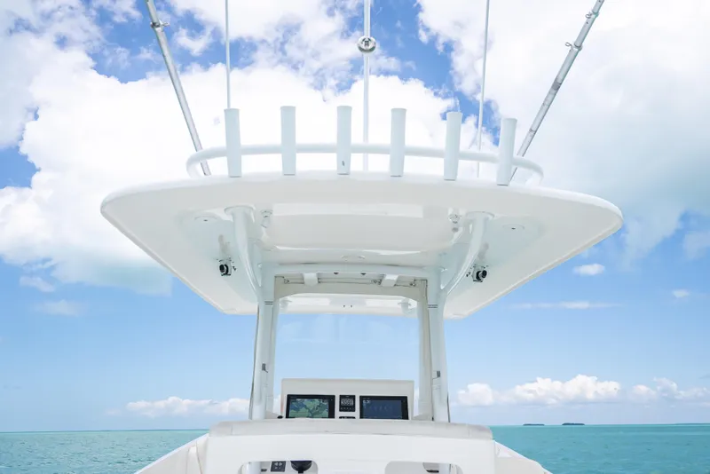 Slide: The Image of 2015 Intrepid 400 Cuddy boat helm against a clear blue sky and ocean backdrop. - 22
