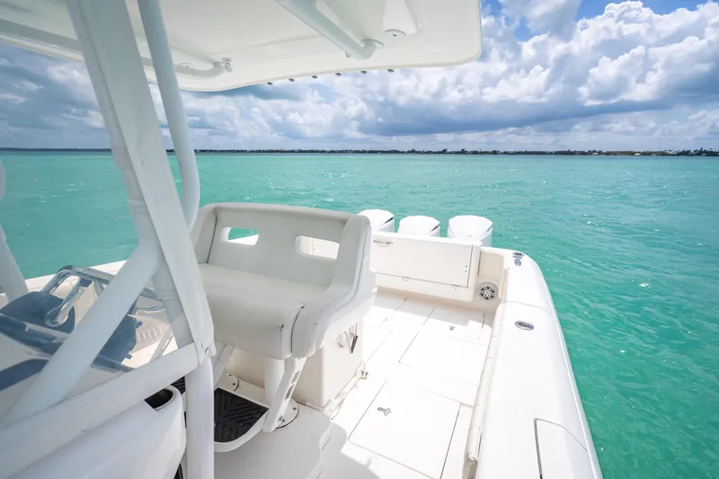 Slide: The Image of 2015 Intrepid 400 Cuddy boat on turquoise water under cloudy sky. - 27