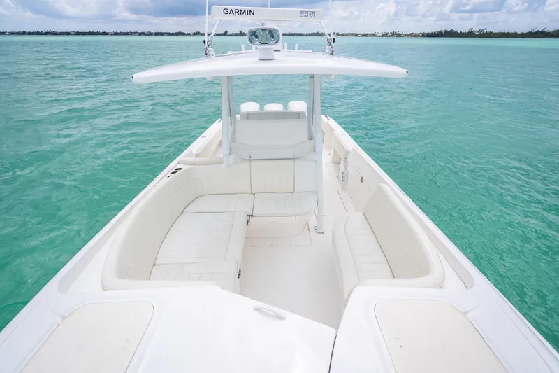 Slide: The Image of 2015 Intrepid 400 Cuddy boat on turquoise water, featuring spacious seating and Garmin equipment. - 29