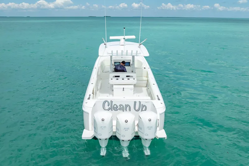 Slide: The Image of 2015 Intrepid 400 Cuddy boat on clear turquoise water, rear view with triple engines. - 3