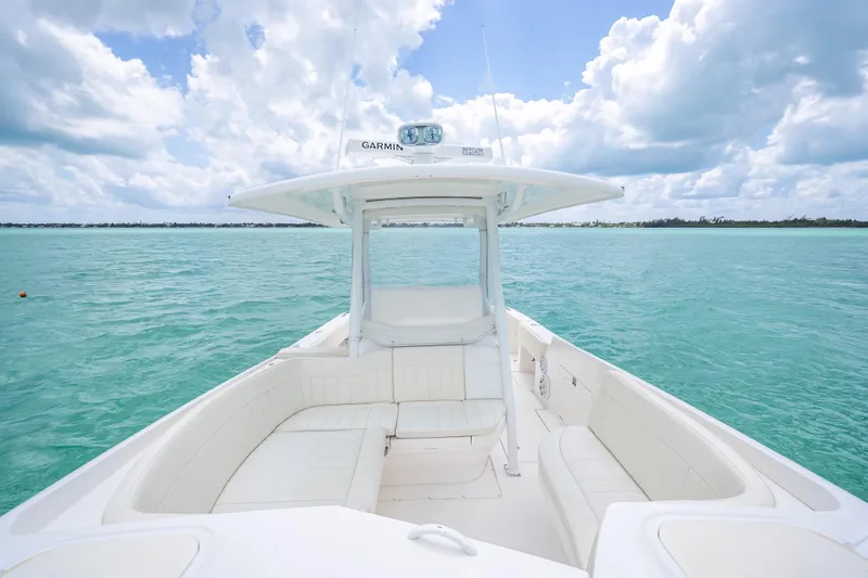 Slide: The Image of 2015 Intrepid 400 Cuddy boat on turquoise water under a cloudy sky. - 30